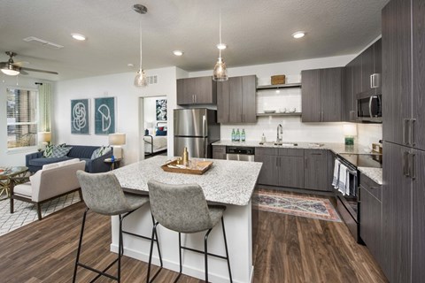 A kitchen with a table and chairs in the middle of the room.