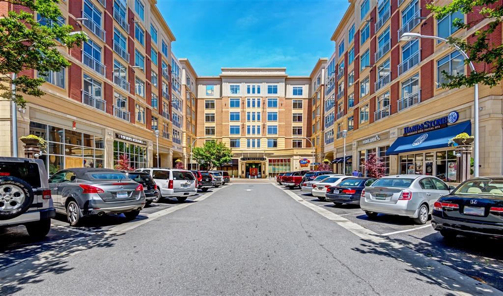 a city street with cars parked in front of buildings