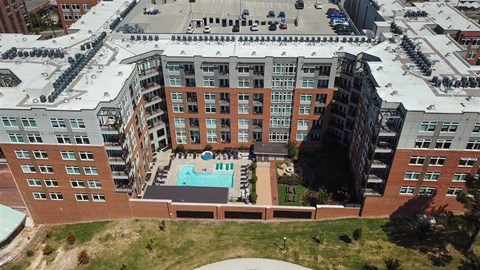 an aerial view of a large building with a swimming pool