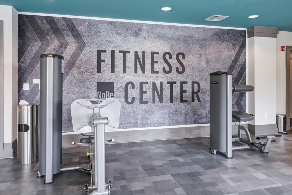 A fitness center with a sign that reads "No Re" and a weight bench.