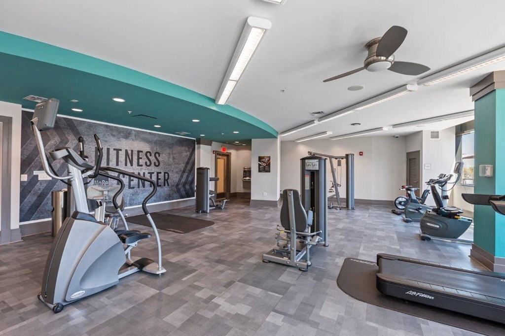 A fitness center with a variety of exercise equipment.