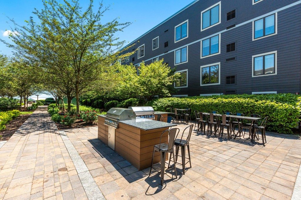 A patio with a table and chairs is in front of a building.