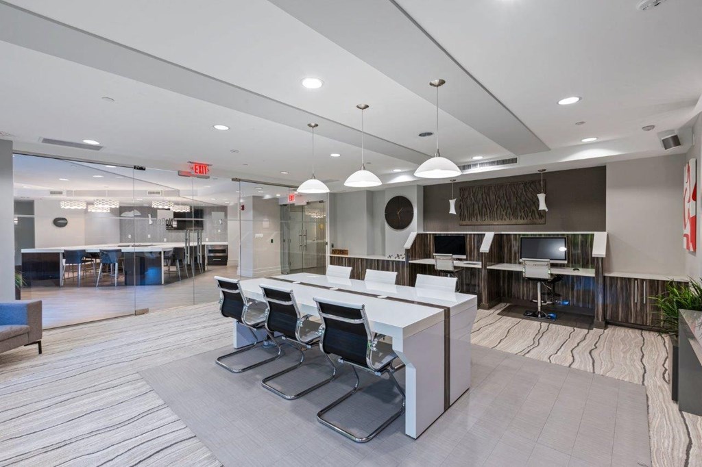 A modern office space with a reception desk and chairs.