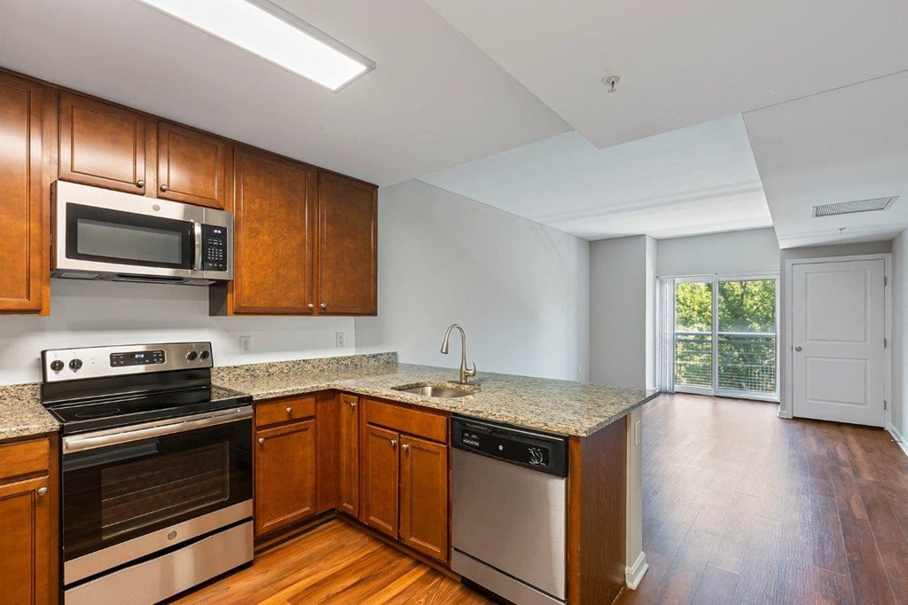 A kitchen with wooden cabinets and stainless steel appliances.