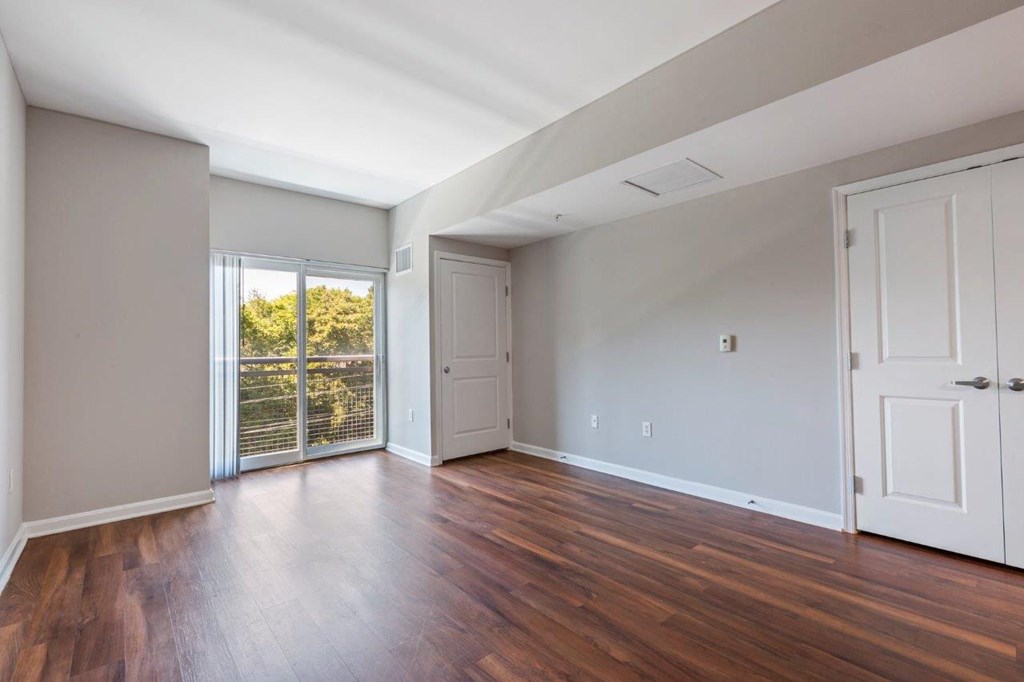 A room with wooden floors and white walls.