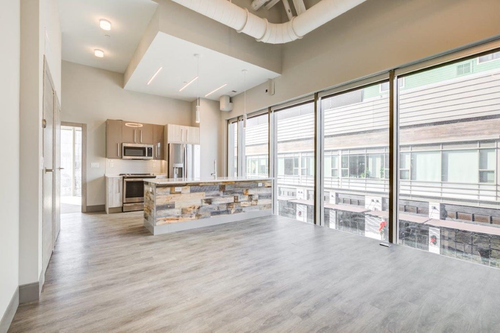 A spacious kitchen with a large island and a view of the city.