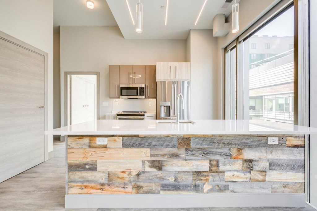 A modern kitchen with a stone counter.