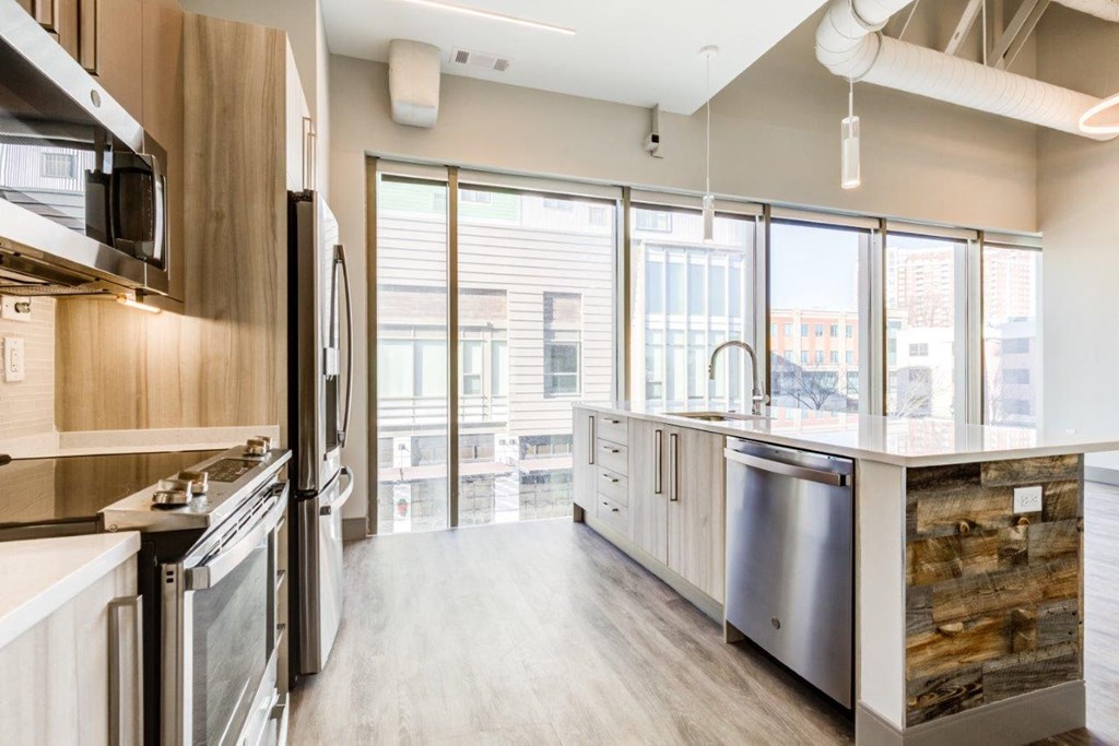 A modern kitchen with stainless steel appliances and wooden accents.