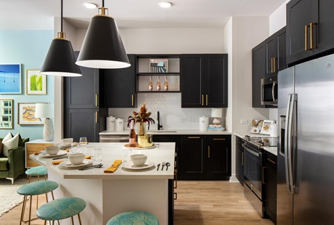 a kitchen with black cabinets and a white counter top
