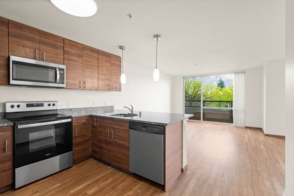 a kitchen with wooden cabinets and stainless steel appliances