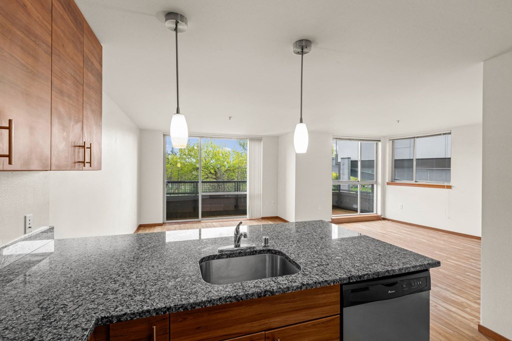 a kitchen with granite countertops and a large window