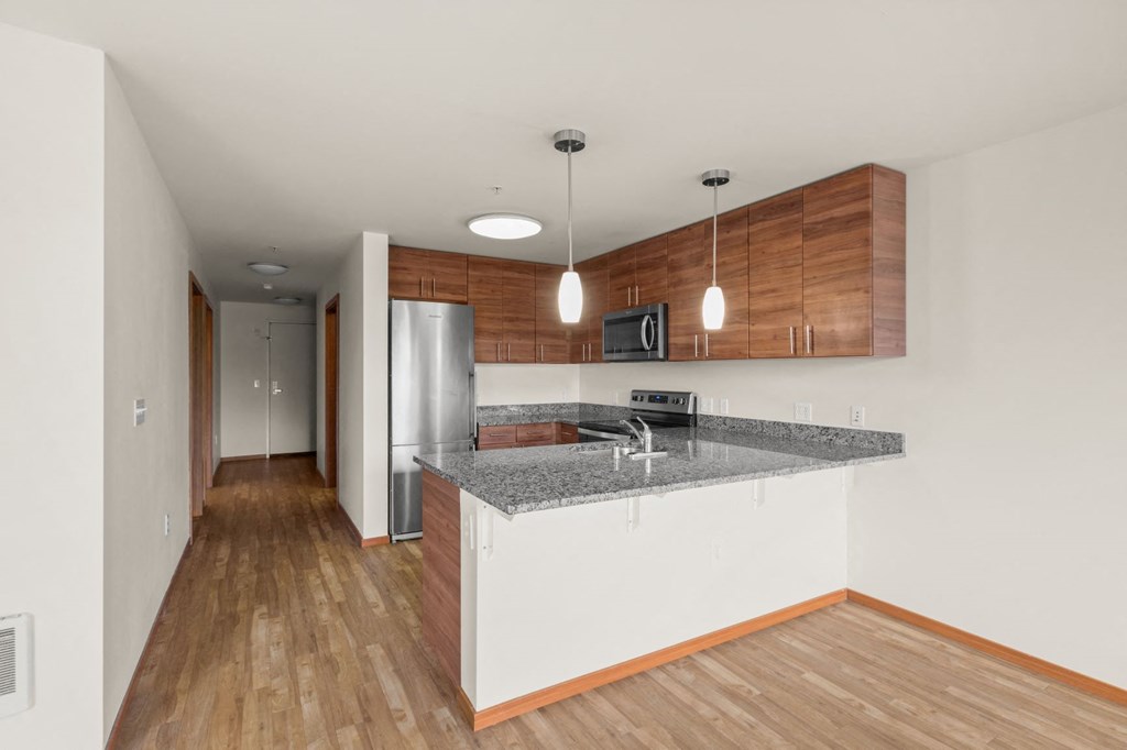a kitchen with granite countertops and stainless steel appliances