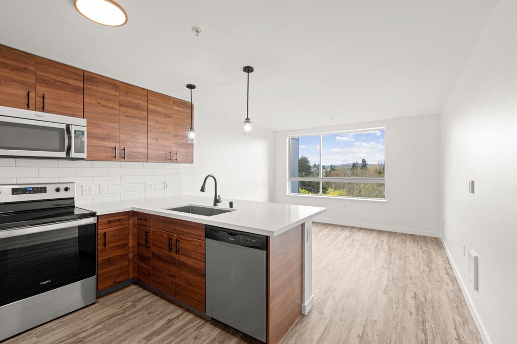a kitchen with white countertops and wooden cabinets