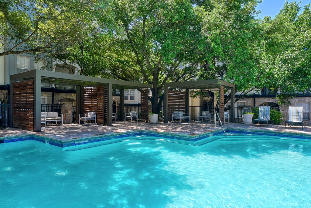 a swimming pool with a tree in the background