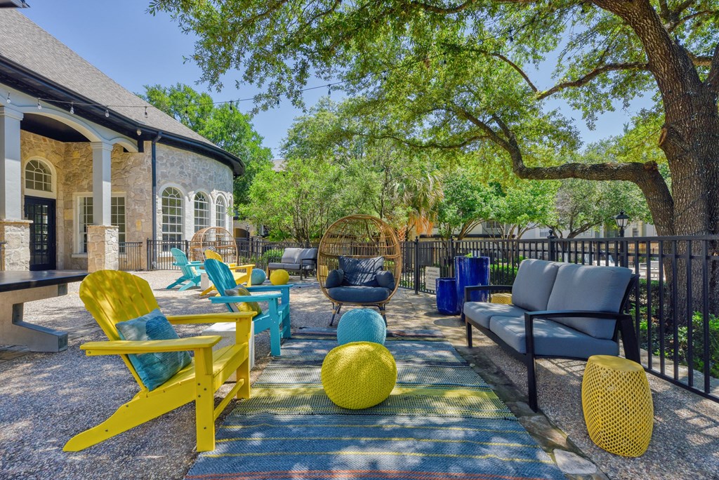 a patio with chairs and couches on a sunny day