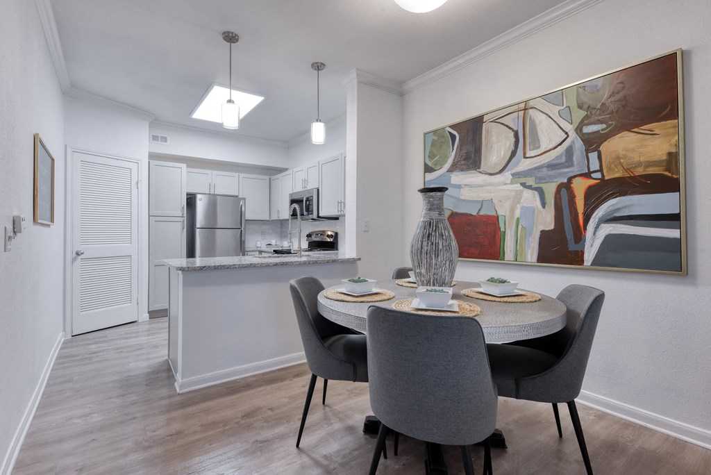 a dining room with a table and chairs