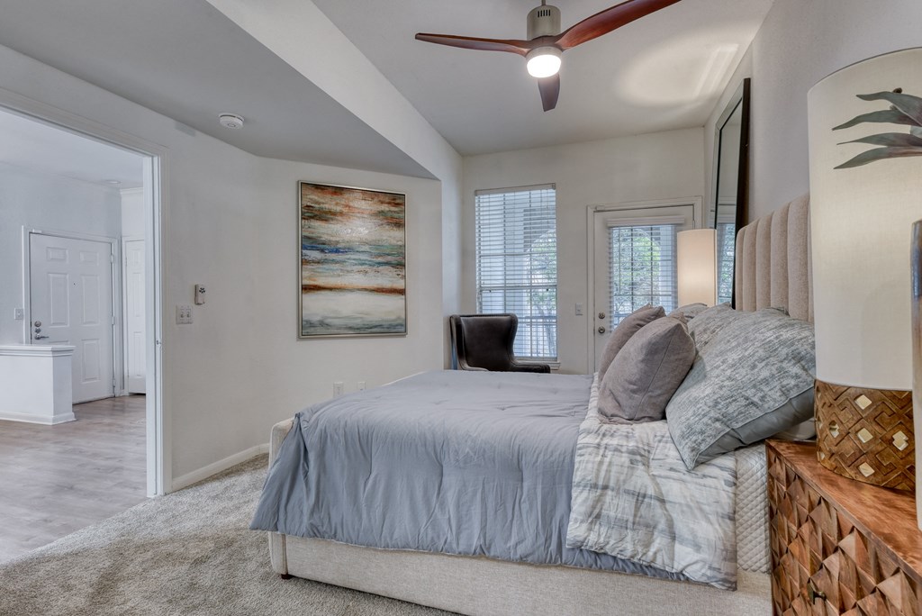 a bedroom with a bed and a ceiling fan