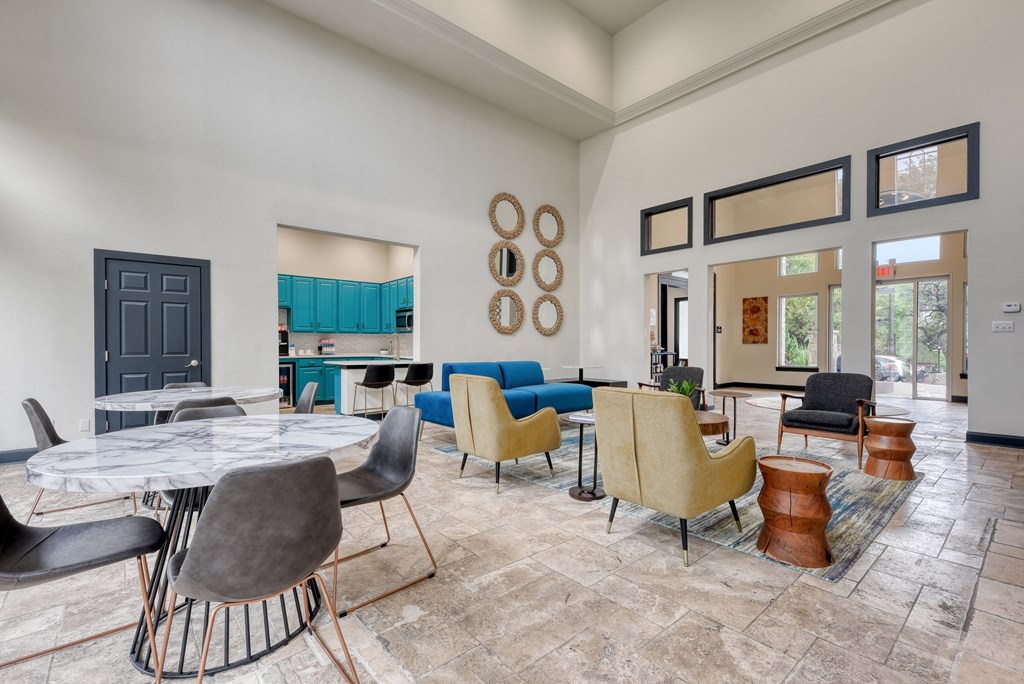 the reserve at bucklin hill clubhouse with tables and chairs and a kitchen in the background