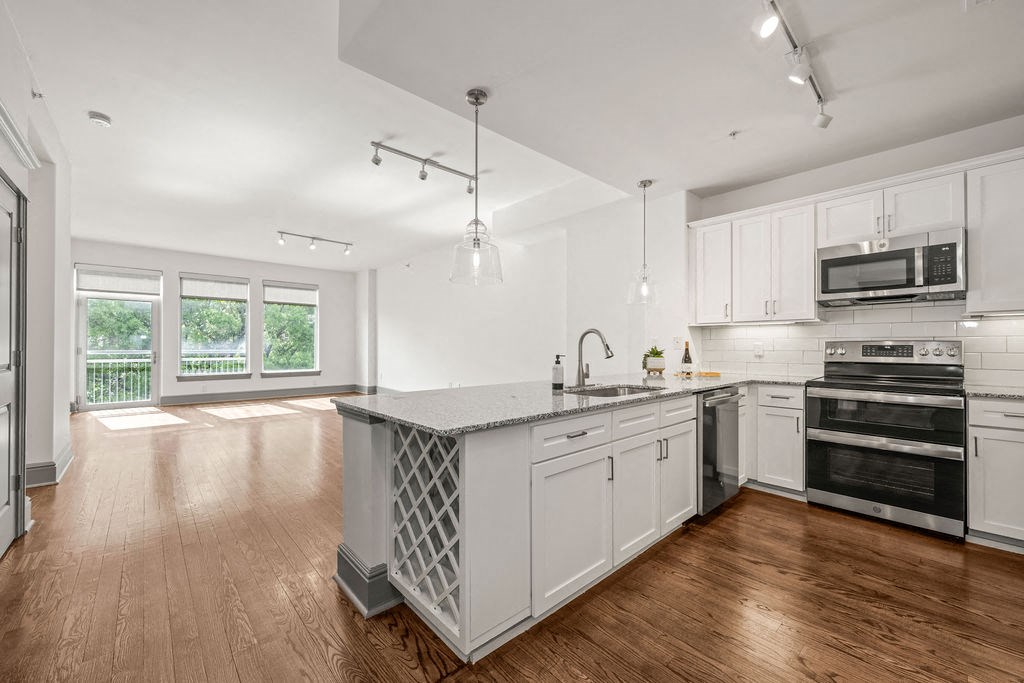 a kitchen with white cabinets and a large island