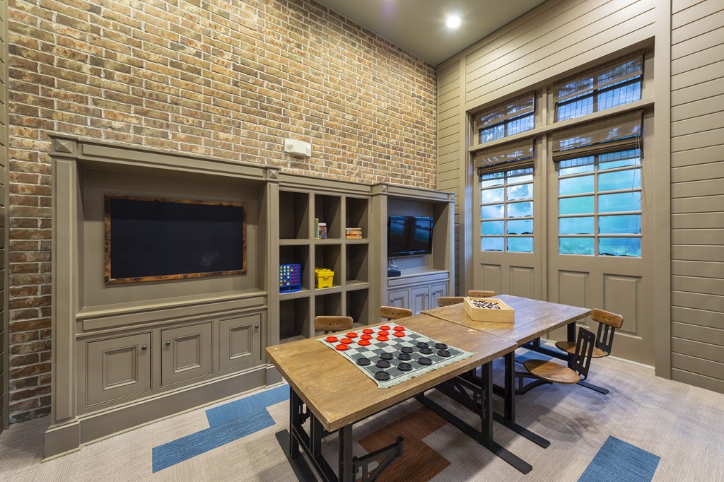 a dining room with a table and a tv
