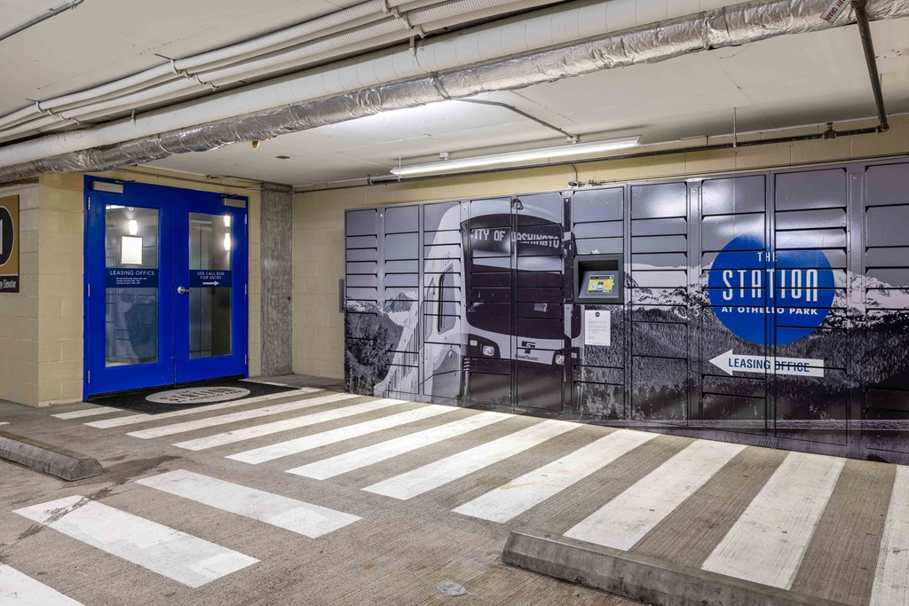 a lobby with a blue door and a mural on the side of a building