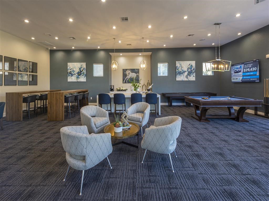 a lounge area with tables and chairs and a pool table