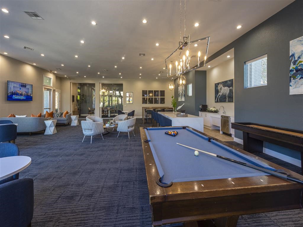 a clubhouse with a pool table and a tv
