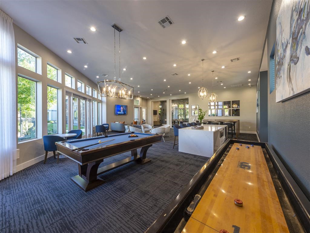 a clubhouse with a pool table and a bowling alley