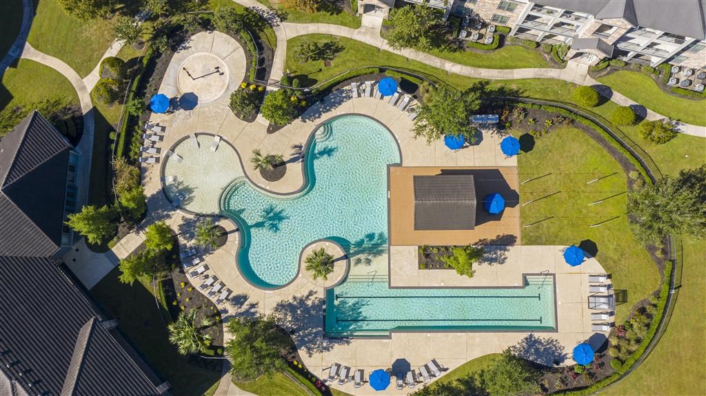 an overhead view of a swimming pool with umbrellas