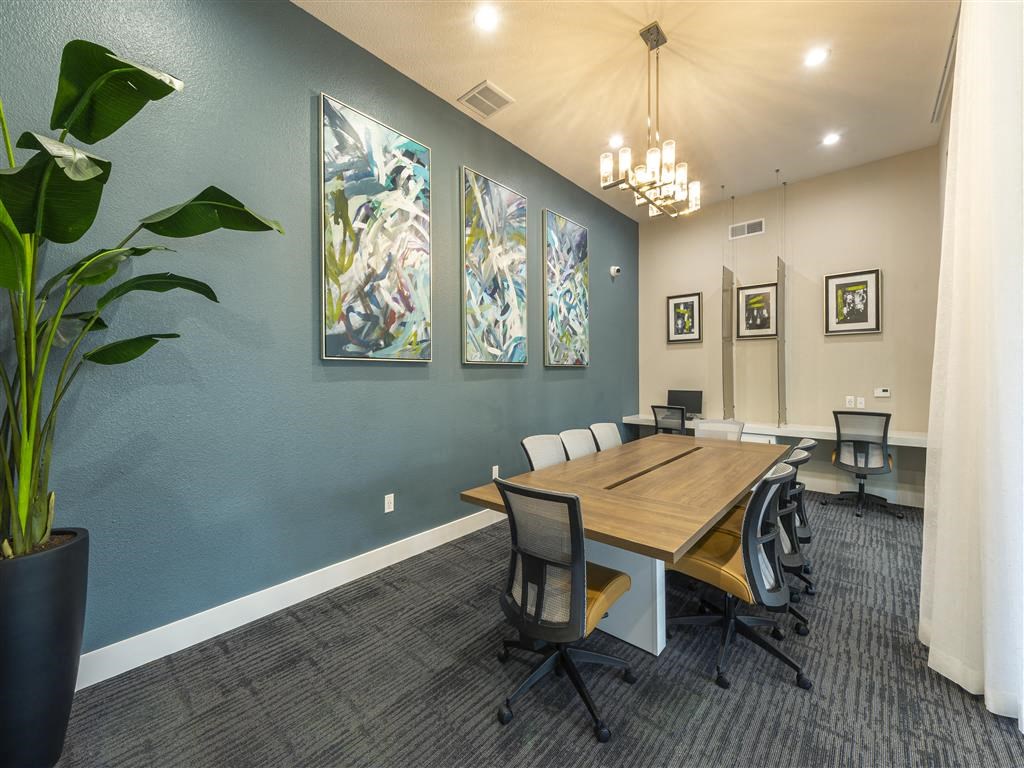 a conference room with a wooden table and chairs