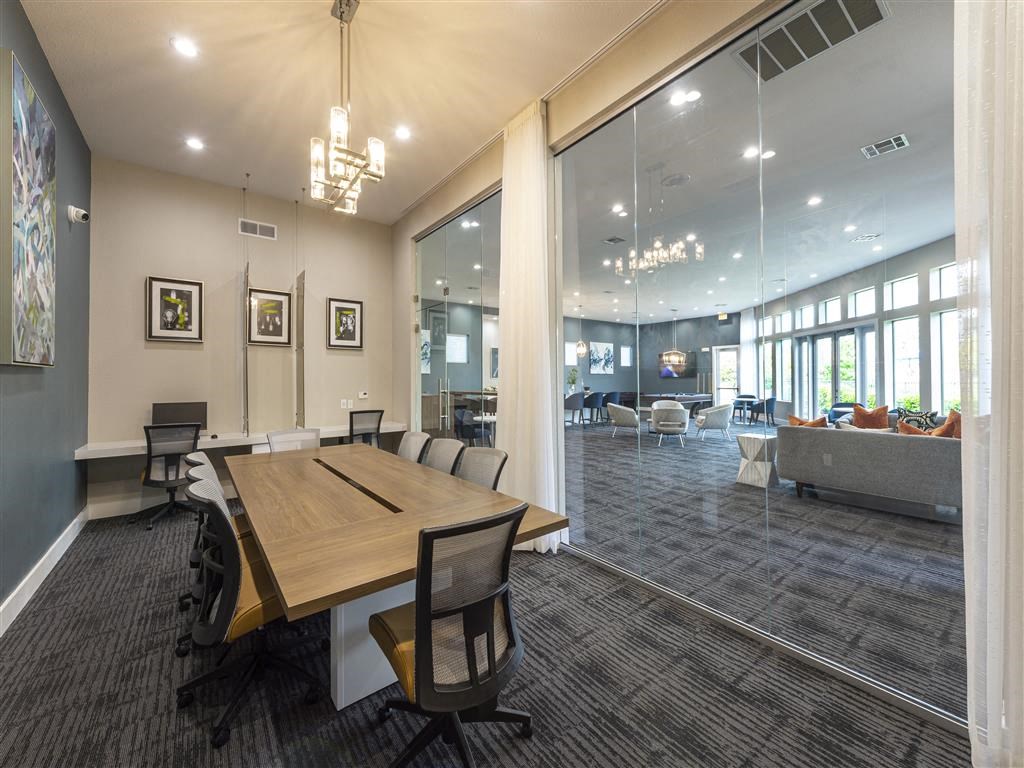 a conference room with a wooden table and chairs