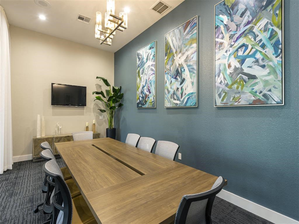 a conference room with a wooden table and chairs