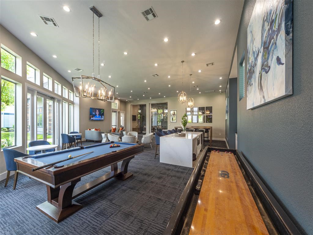a clubhouse with a pool table and a bar