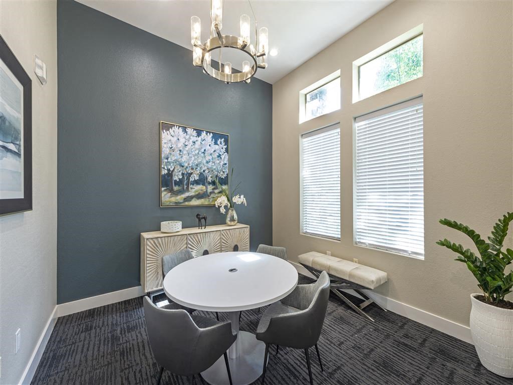 a dining room with a table and chairs and a chandelier