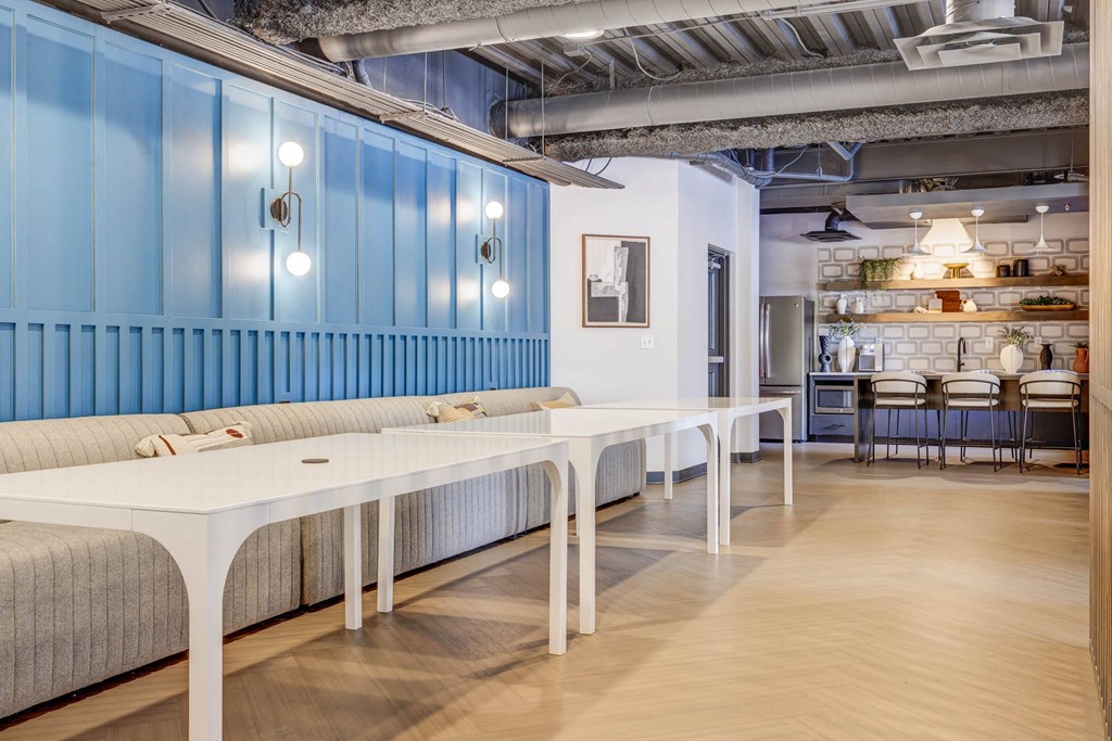 a dining room with blue walls and white tables