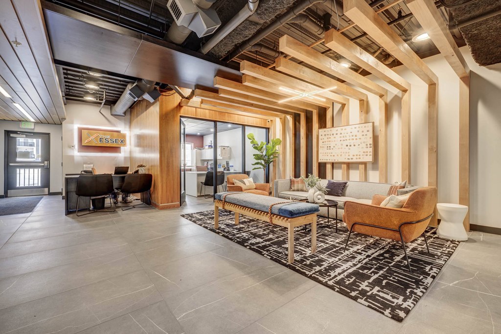 a lobby with couches and chairs and a rug