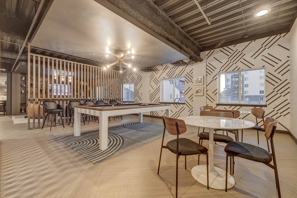 a dining room with tables and chairs and a large table with chairs