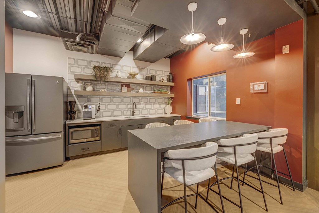 a kitchen with a table and chairs and a refrigerator