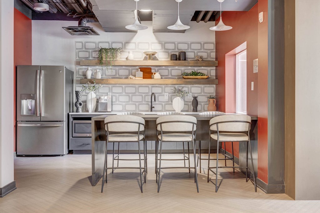 a kitchen with a table and chairs and a refrigerator