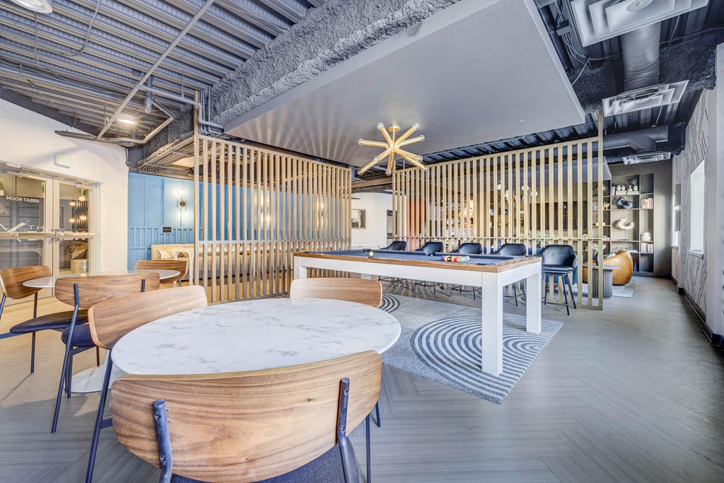 a dining room with tables and chairs and a pool table