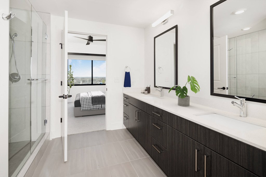 a bathroom with a sink and a shower and a mirror