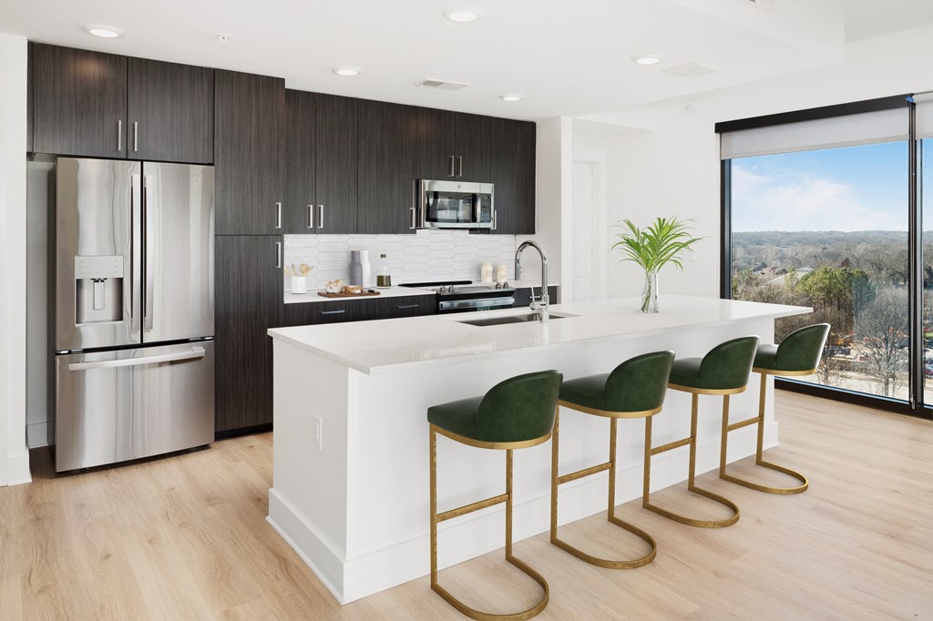 a kitchen with a large island with green bar stools