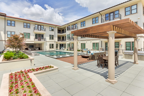 a backyard with a pool and patio with a wooden awning