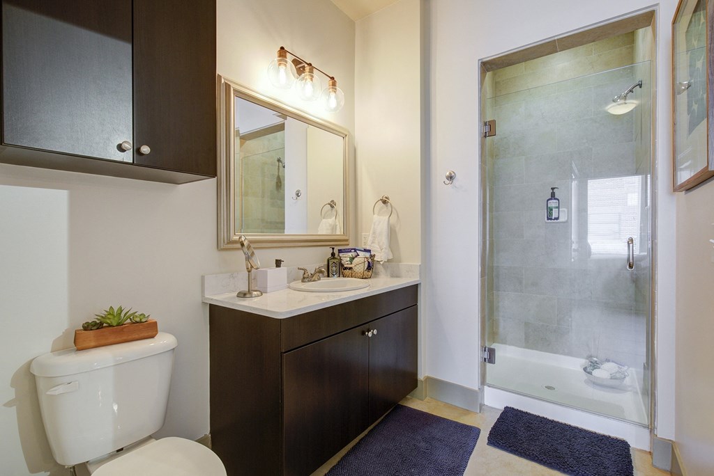 a bathroom with a toilet sink and shower