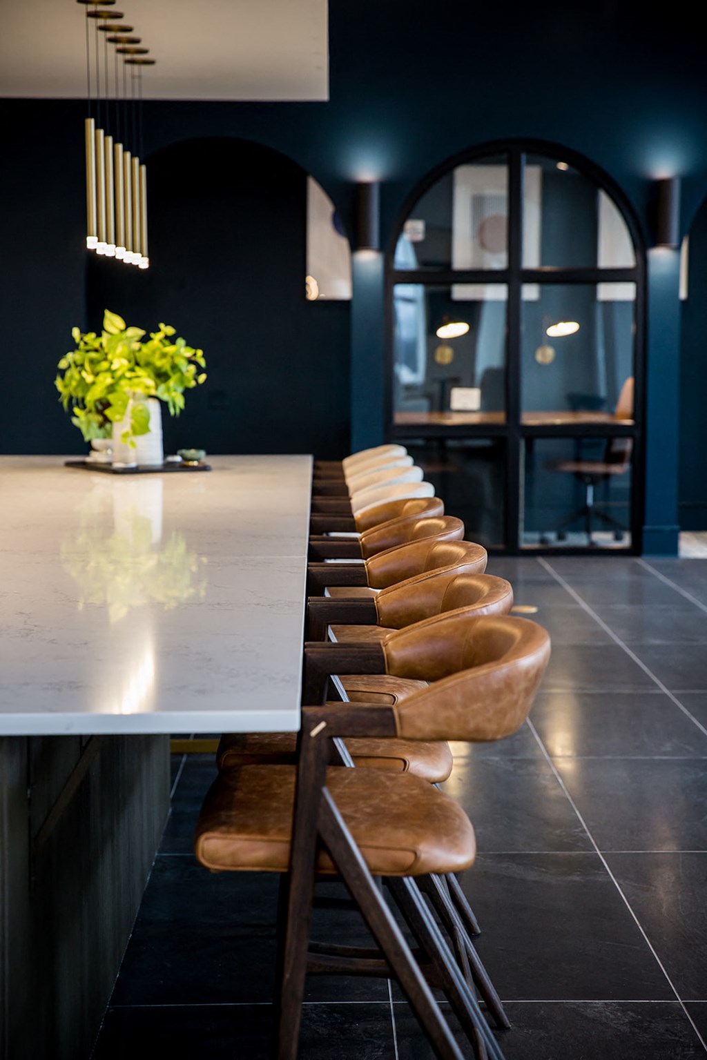 a view of the kitchen with a long countertop and a long table with a row of
