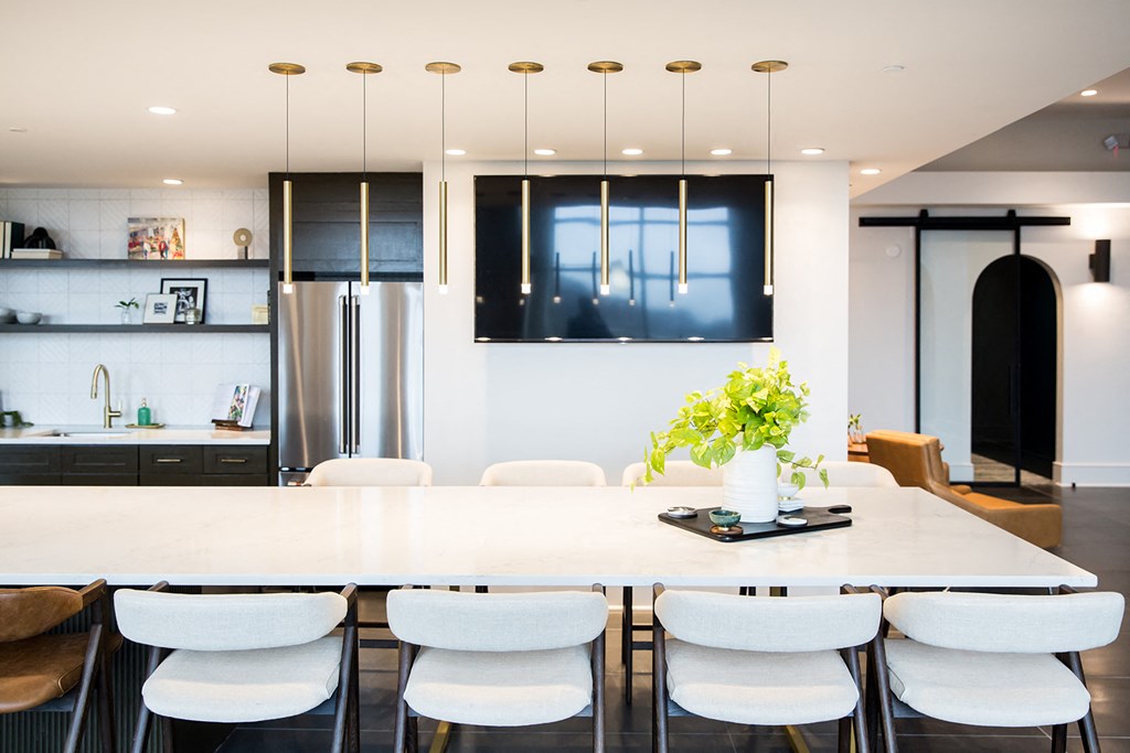 a kitchen with white walls and a large white table with white chairs