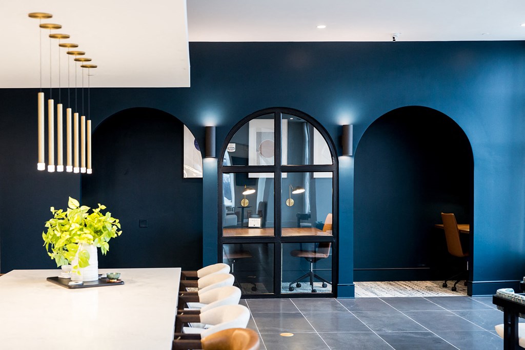 a dark blue room with a white table and chairs