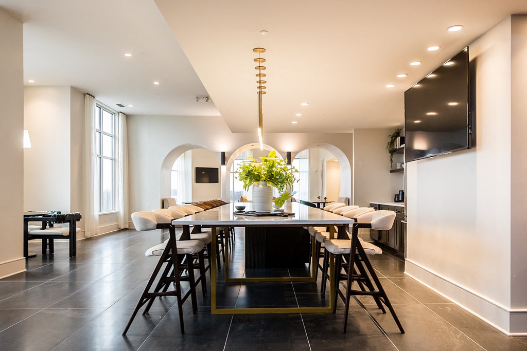 a view of the dining room with the kitchen in the background
