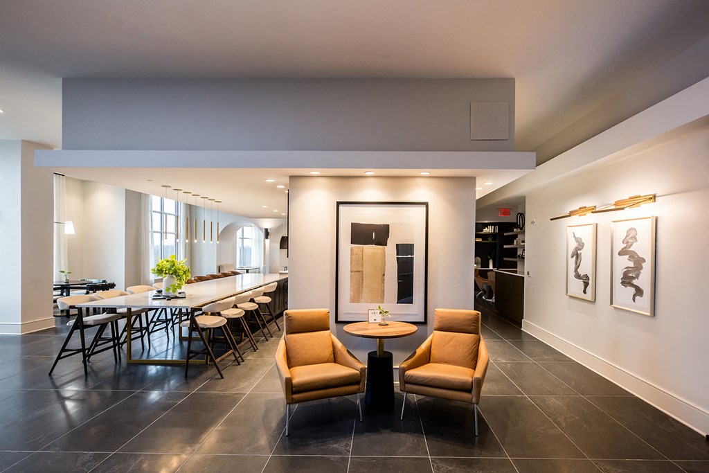 a dining area with chairs and tables and a bar in the background