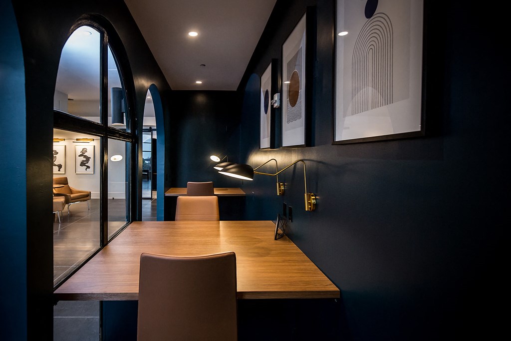 a dark blue room with a wooden table and chairs